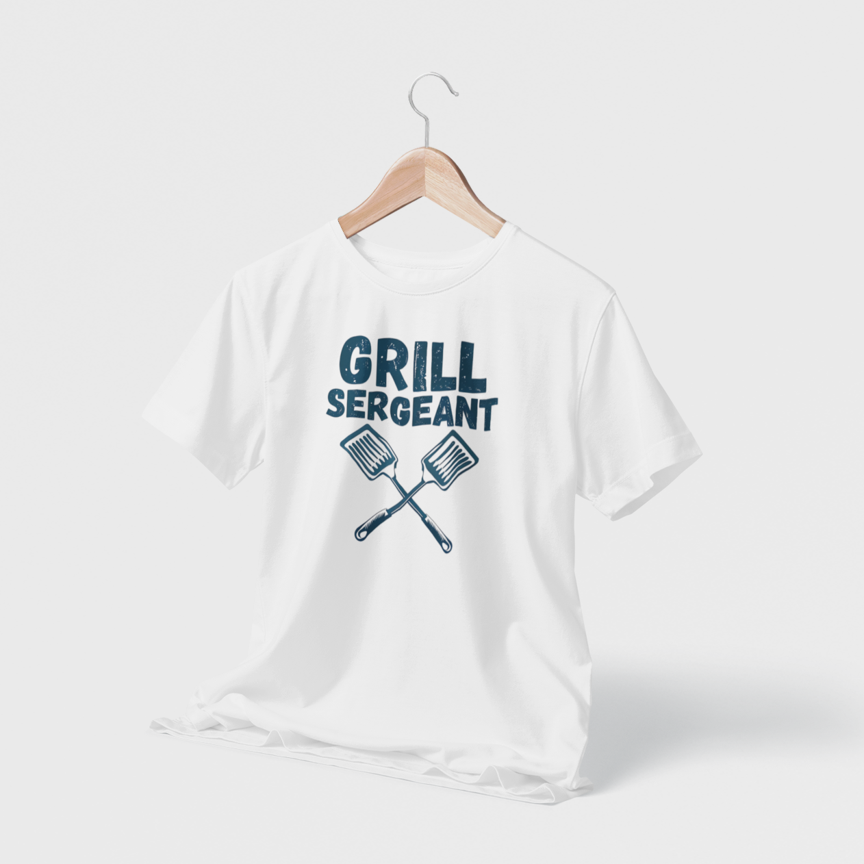 White hanging t-shirt with “Grill Sergeant” text and crossed spatula design