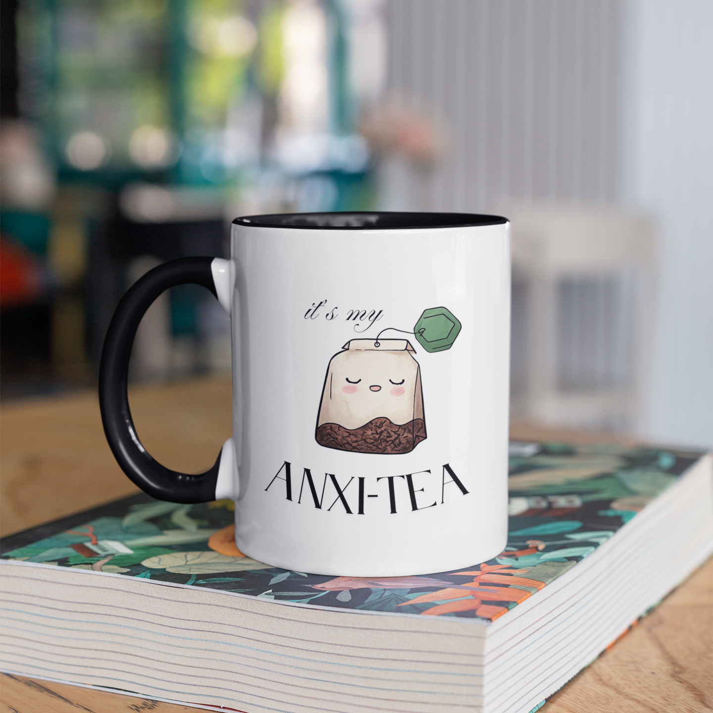 Funny 15 oz coffee mug with cartoon tea bag and “It’s My Anxie-Tea” mental health quote with black handles