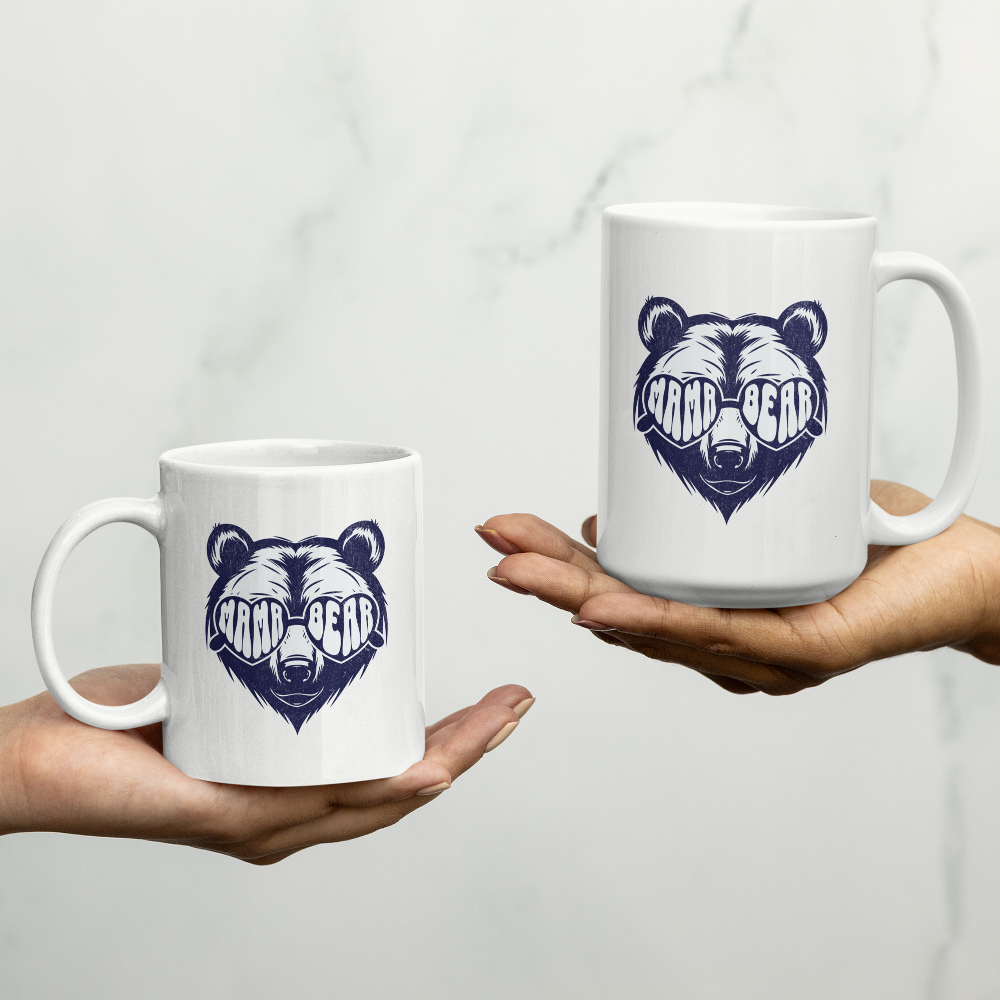 White 'Mama Bear' ceramic coffee mug with bold bear graphic, available in 11 oz and 15 oz sizes, featuring a durable two-tone design.