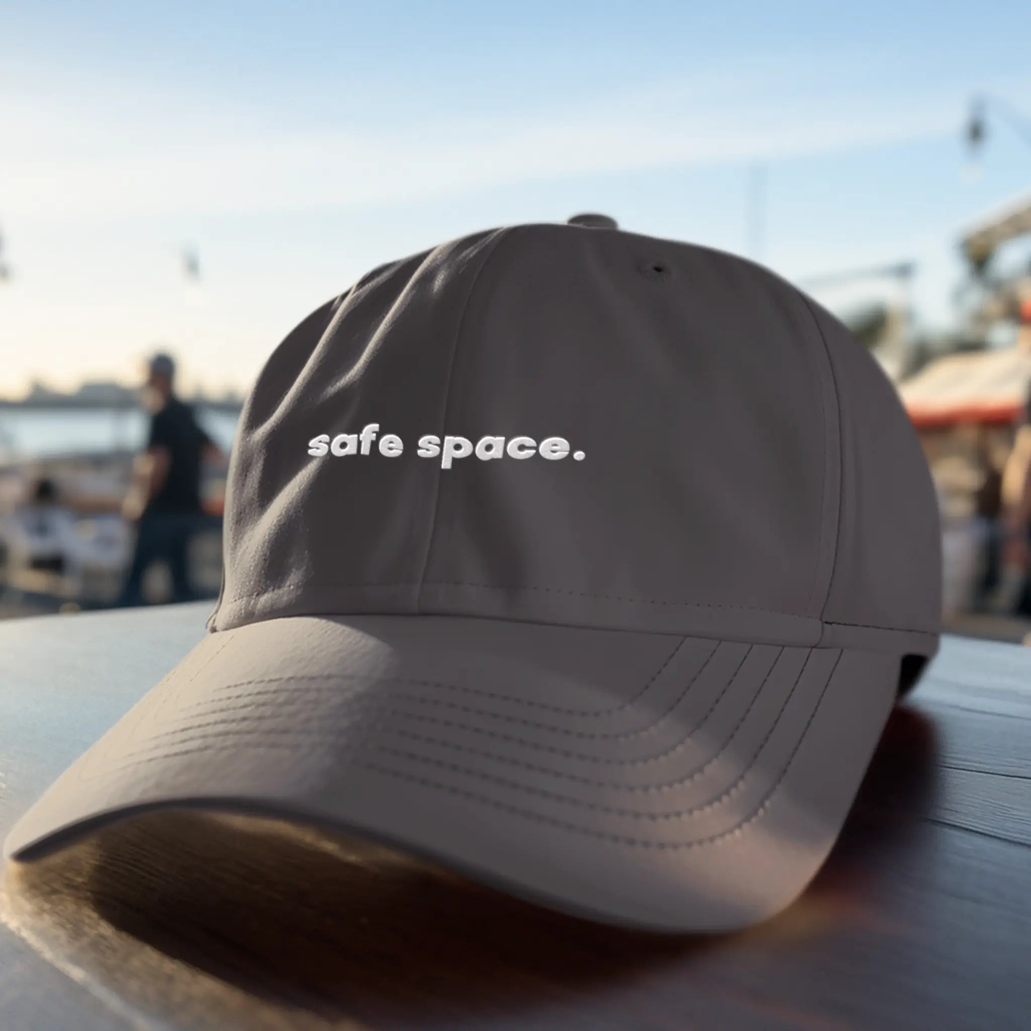 Embroidered “safe space.” hat for LGBTQ allies, charcoal dad cap with white stitching