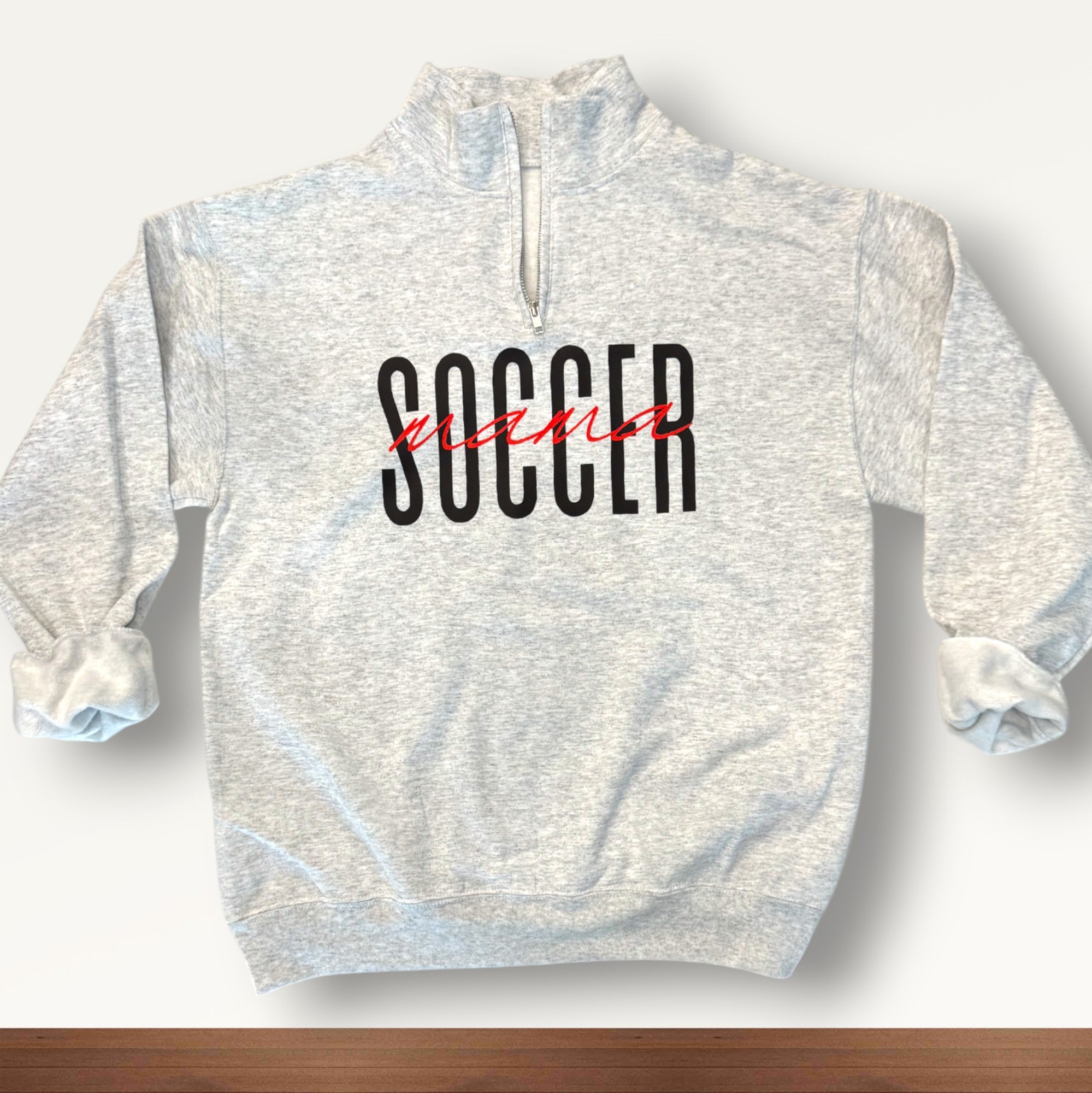 Ash Customizable 'Sports Mama' 1/4 zip pullover for soccer moms and sports fans, featuring a soft fabric and stylish design, perfect for game days.
