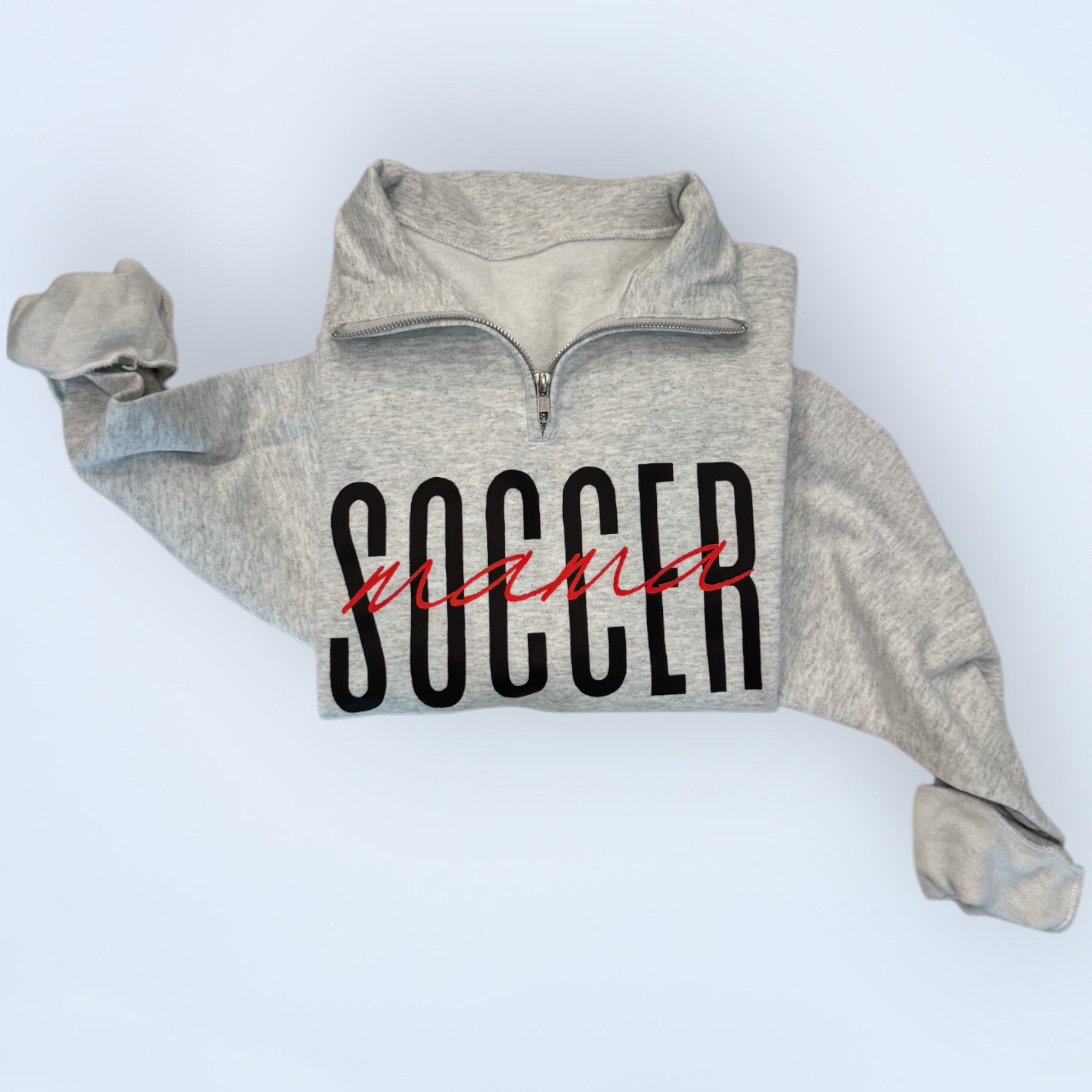 folded ash Customizable 'Sports Mama' 1/4 zip pullover for soccer moms and sports fans, featuring a soft fabric and stylish design, perfect for game days.