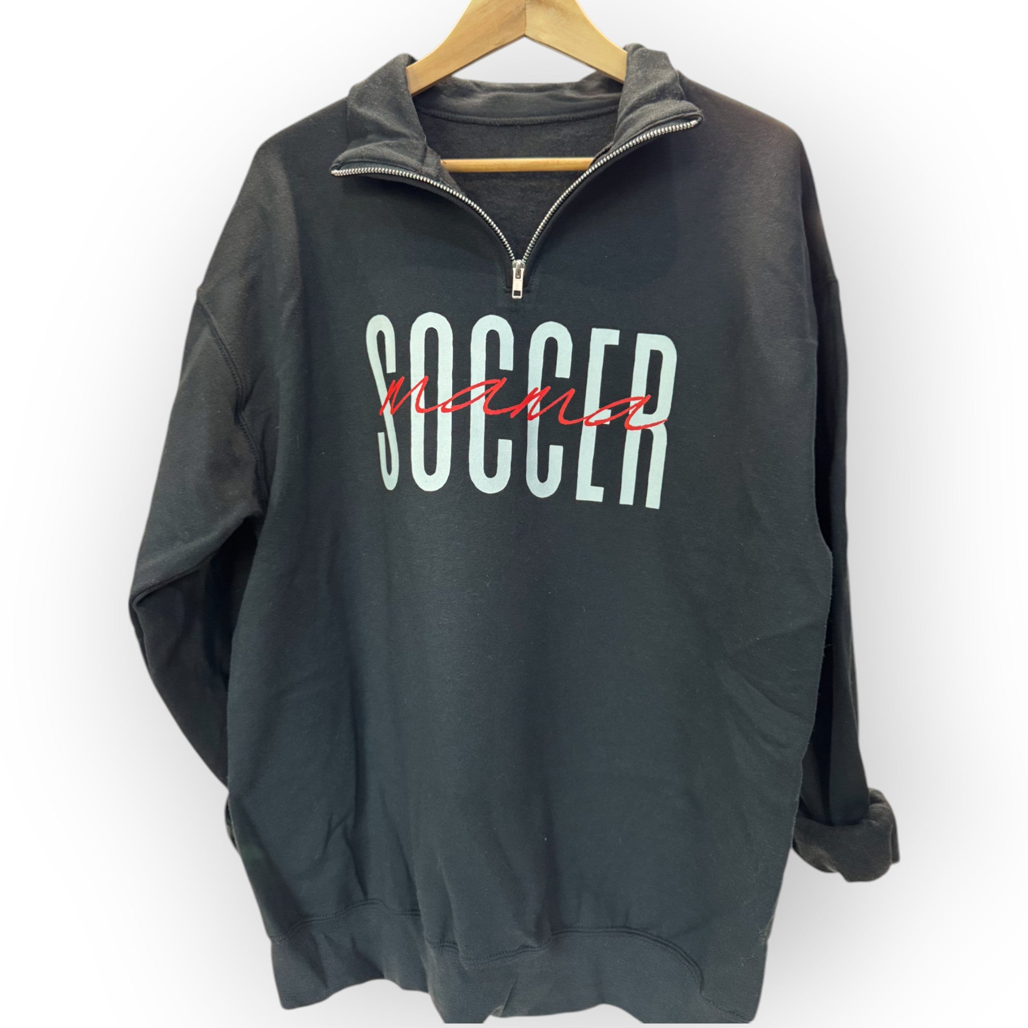 hanging black Customizable 'Sports Mama' 1/4 zip pullover for soccer moms and sports fans, featuring a soft fabric and stylish design, perfect for game days.