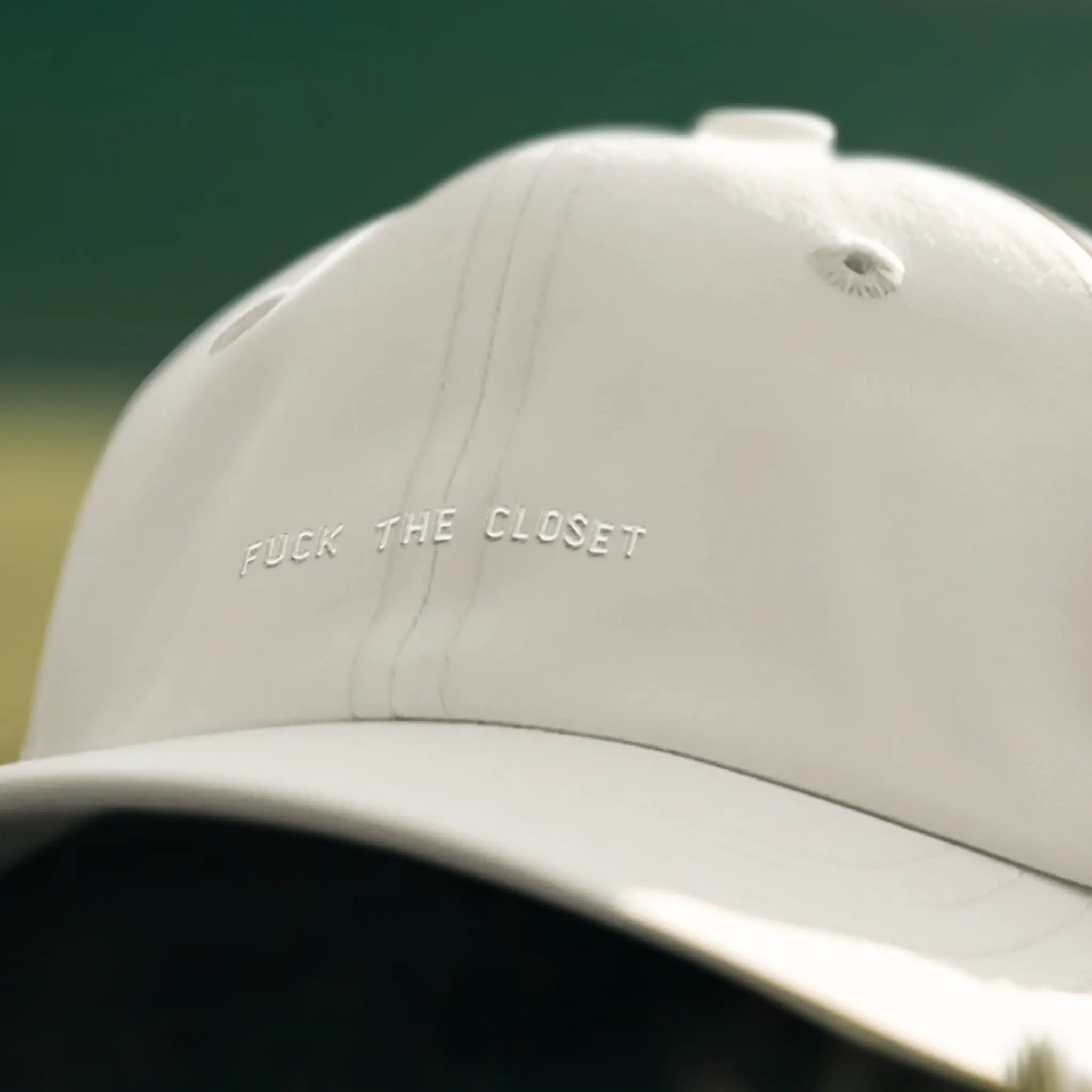 White cap with embroidered “Fuck the Closet” lettering, queer ally pride hat