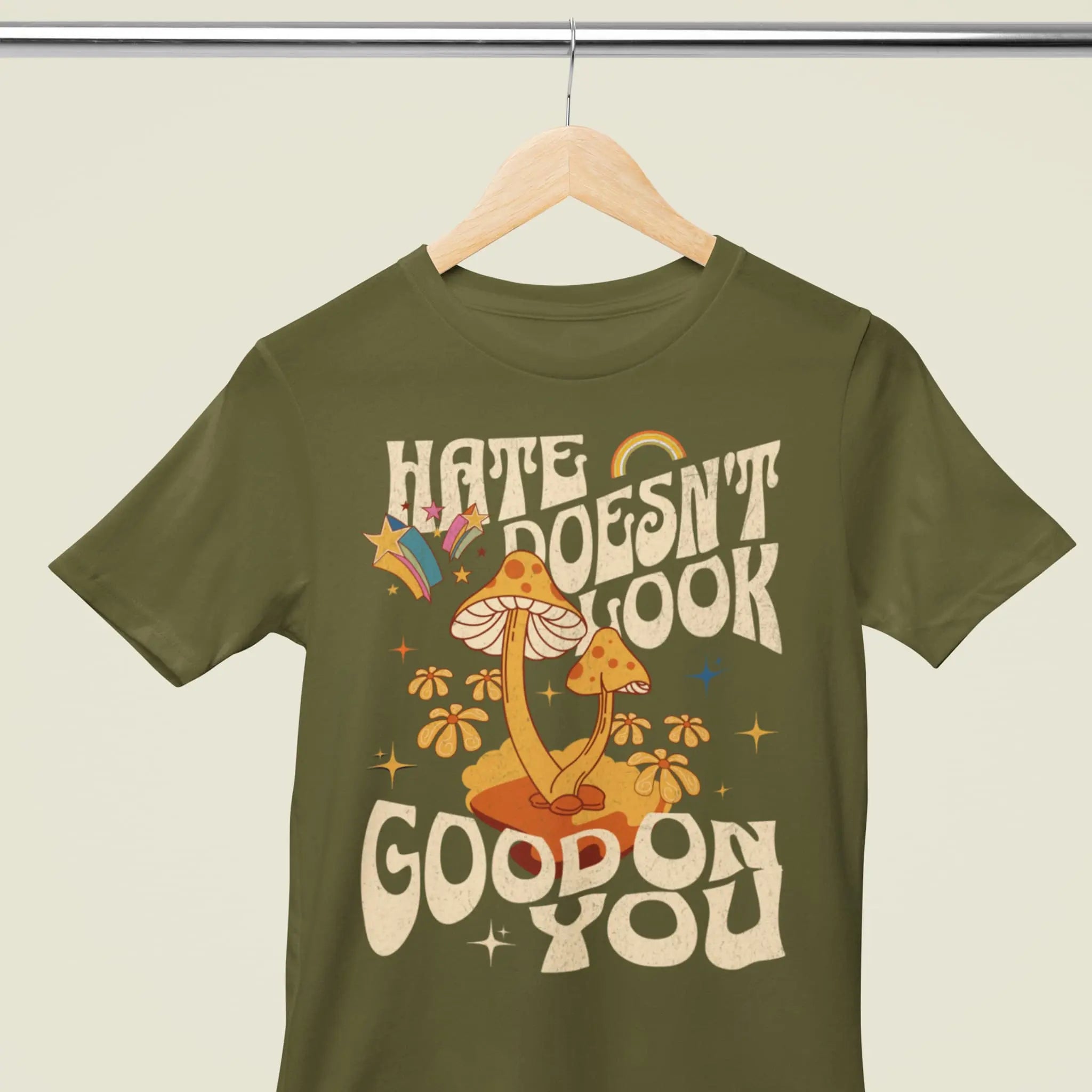 Retro style mushroom t-shirt with “Hate Doesn’t Look Good On You” saying, inclusive positive apparel
