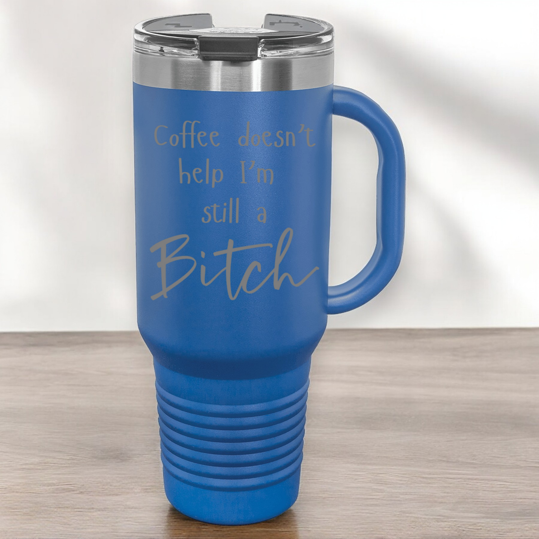 Royal 40 oz stainless steel tumbler with a lid, featuring the humorous engraved quote, "Coffee doesn’t help, I’m still a bitch," and a built-in handle.