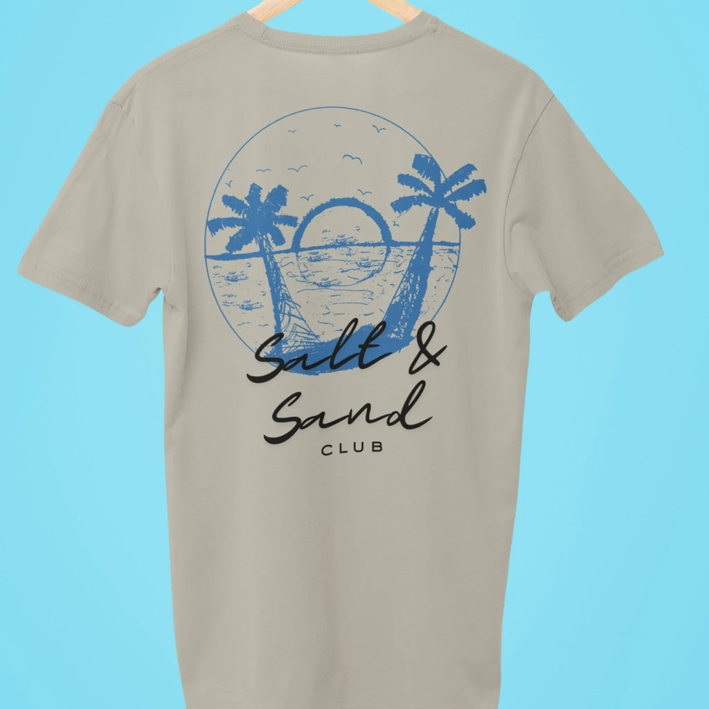 Coastal beachwear t-shirt with large “Salt & Sand Club” back print featuring palm trees and sunset, white tee