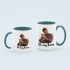 Light Blue 'Oh Hey There' coffee mug featuring Trump holding a cat, available in 11 oz and 15 oz sizes with a durable ceramic design and blue handle.