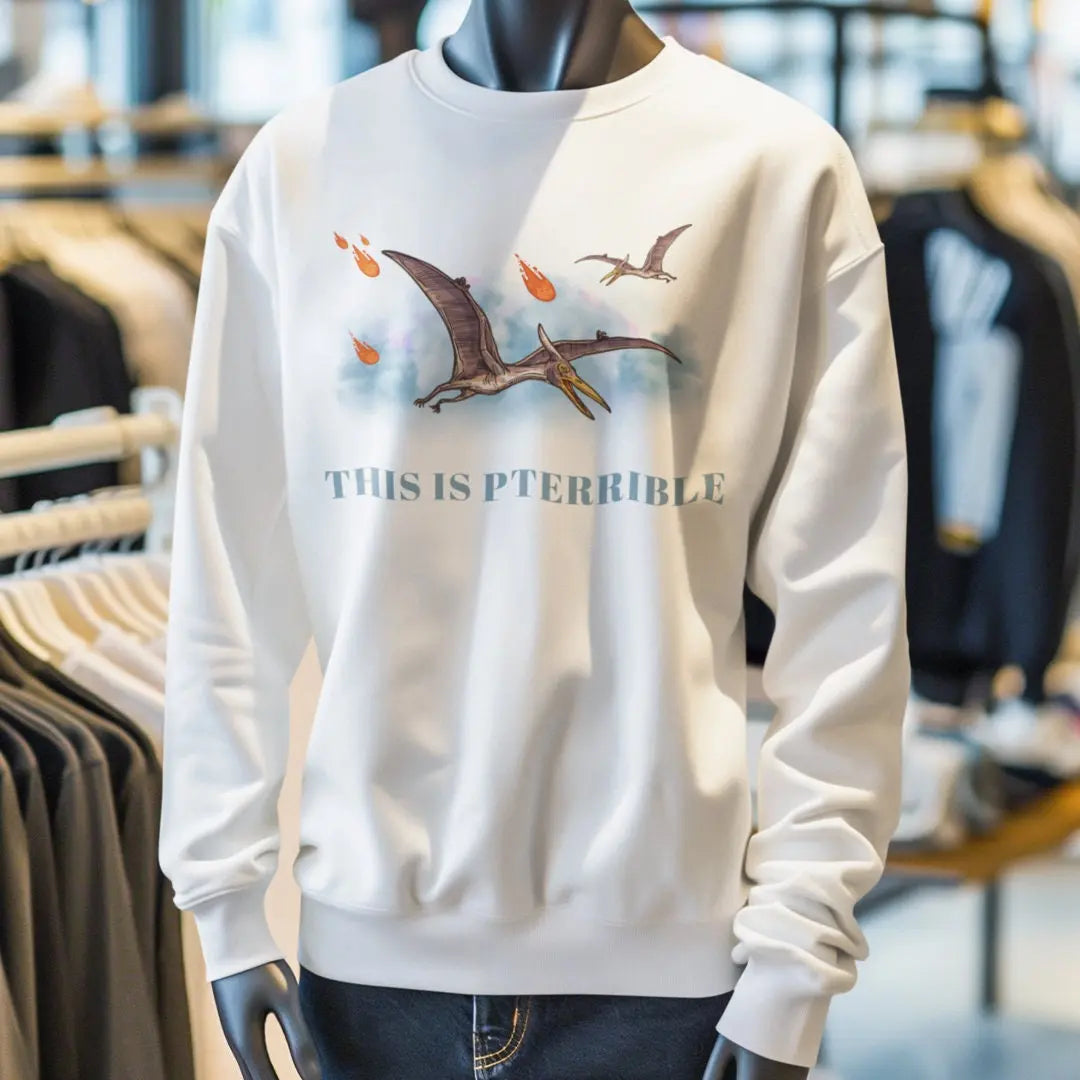 Crewneck sweatshirt mockup showing pterodactyl and meteor graphic with “This Is Pterrible” dinosaur pun text