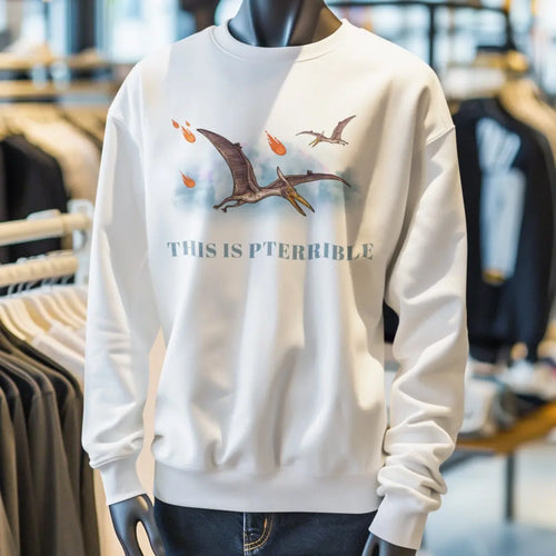 Crewneck sweatshirt mockup showing pterodactyl and meteor graphic with “This Is Pterrible” dinosaur pun text