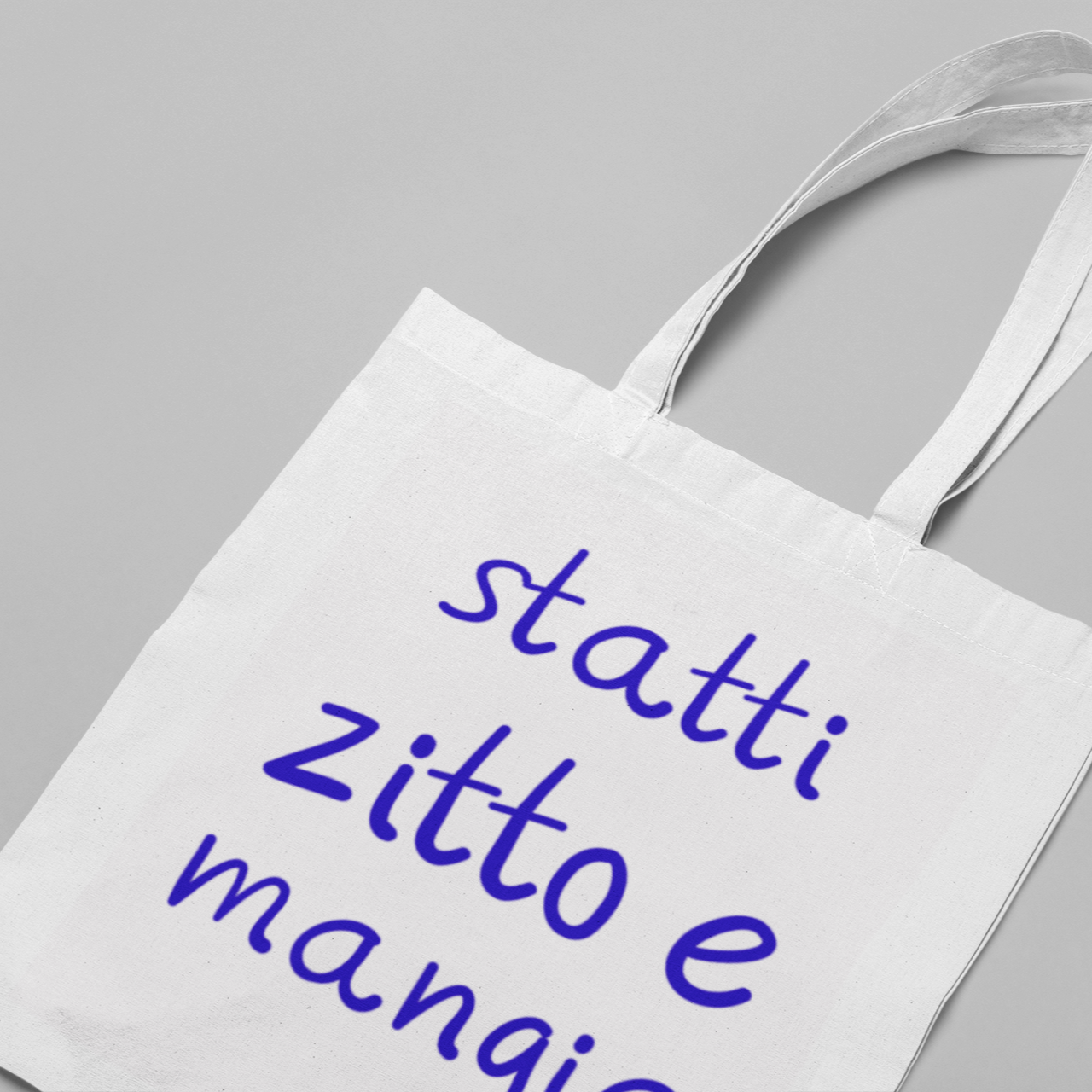 Canvas tote bag with purple text reading “statti zitto e mangia”