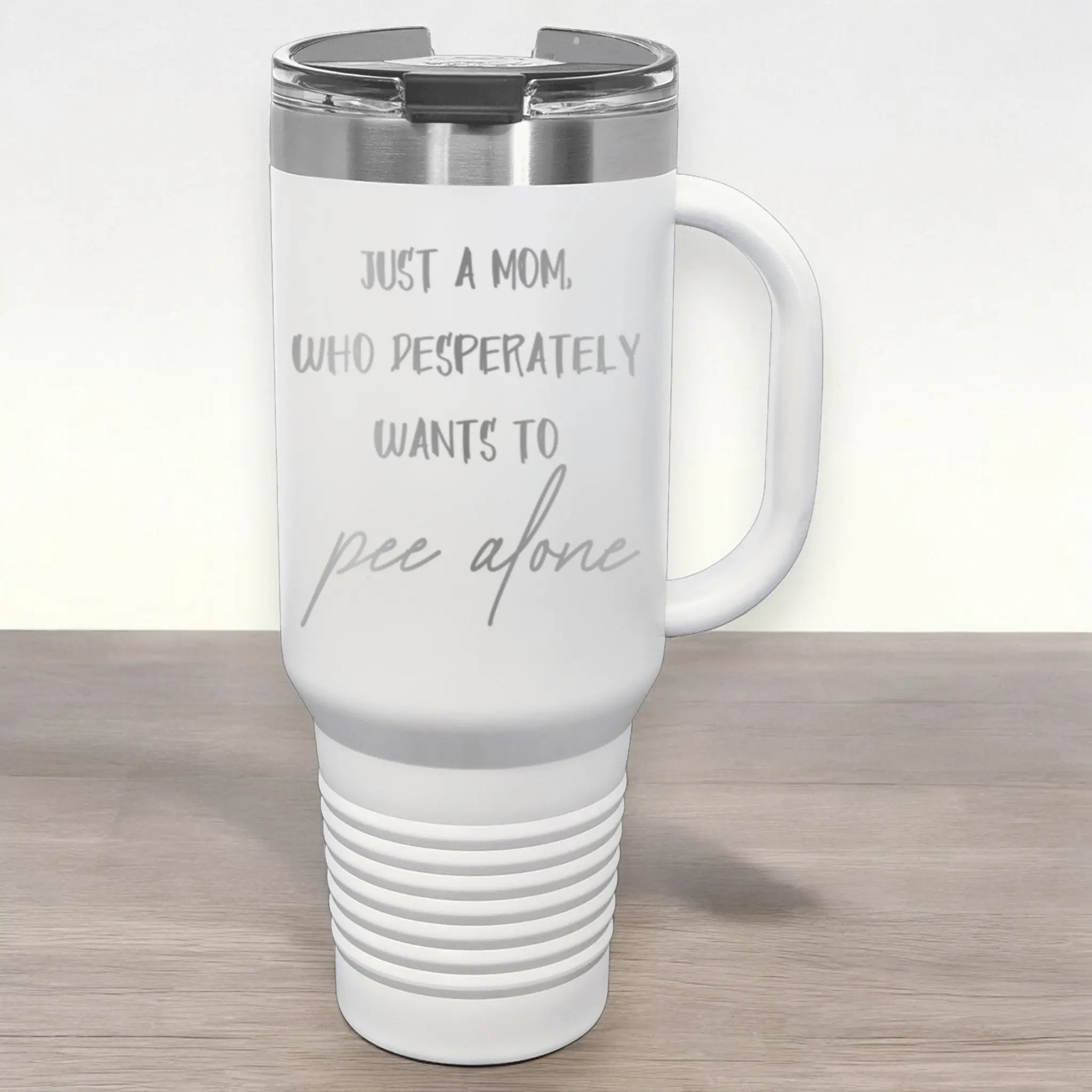Flat lay of 40oz laser engraved mom pee alone tumbler white - stainless steel insulated drinkware for moms who never pee alone