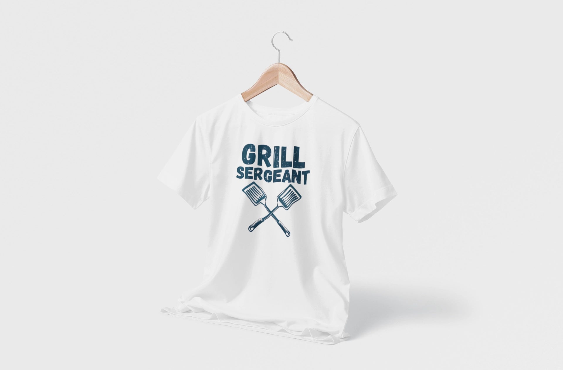 White t-shirt with 'Grill Sergeant' text and crossed spatula graphics on a white background